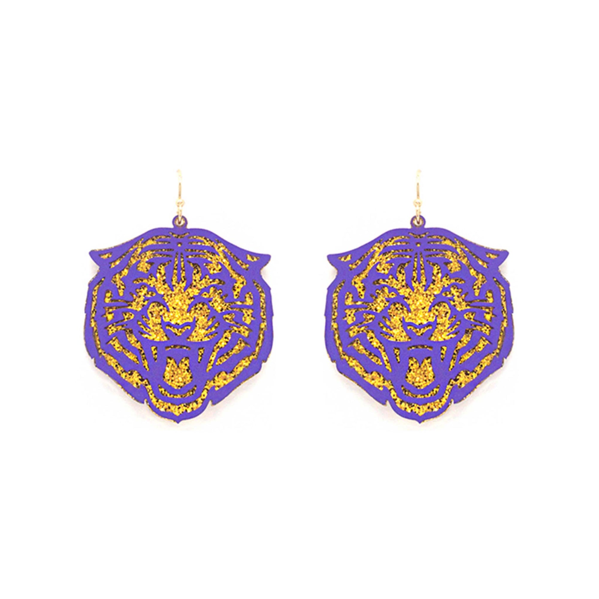 Purple dangle earrings shaped like a tiger's face with gold glitter accents, shown against a white background.