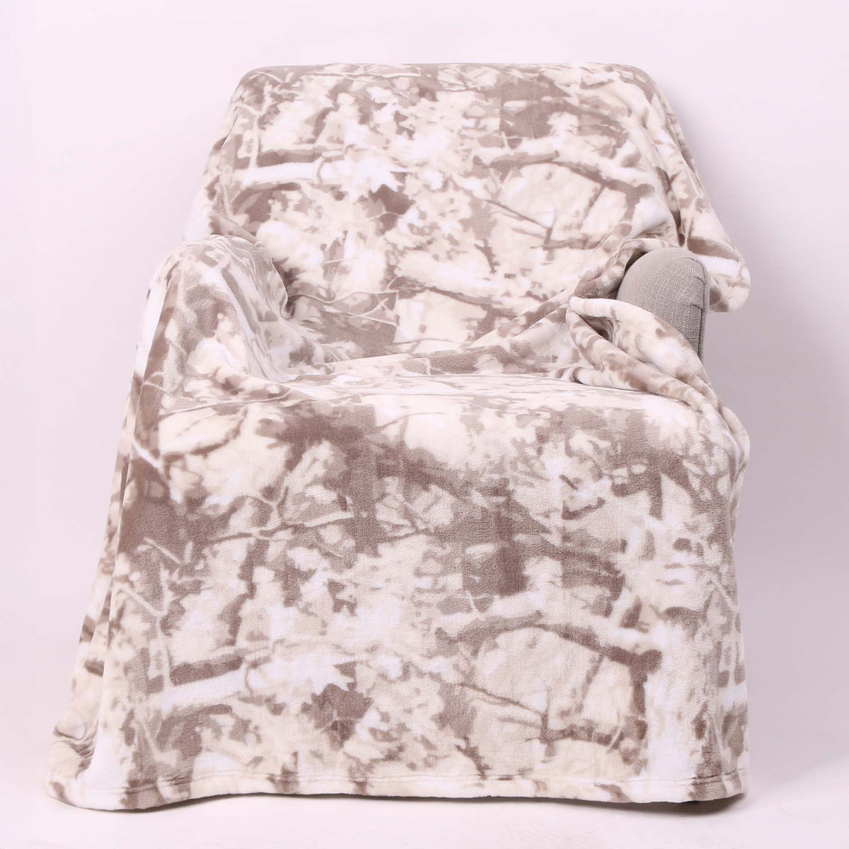 White camo fleece blanket laid out over a chair.