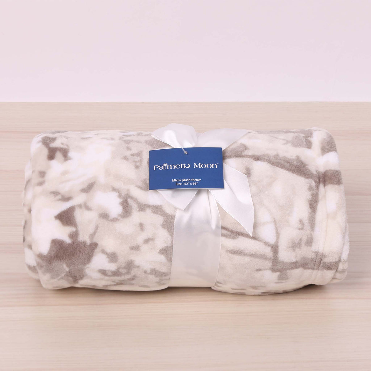 White Camo folded blanket and tied with a bow.