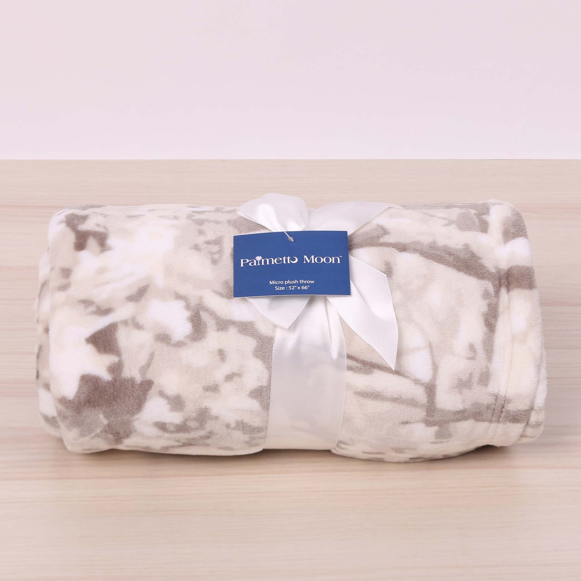 White Camo folded blanket and tied with a bow.