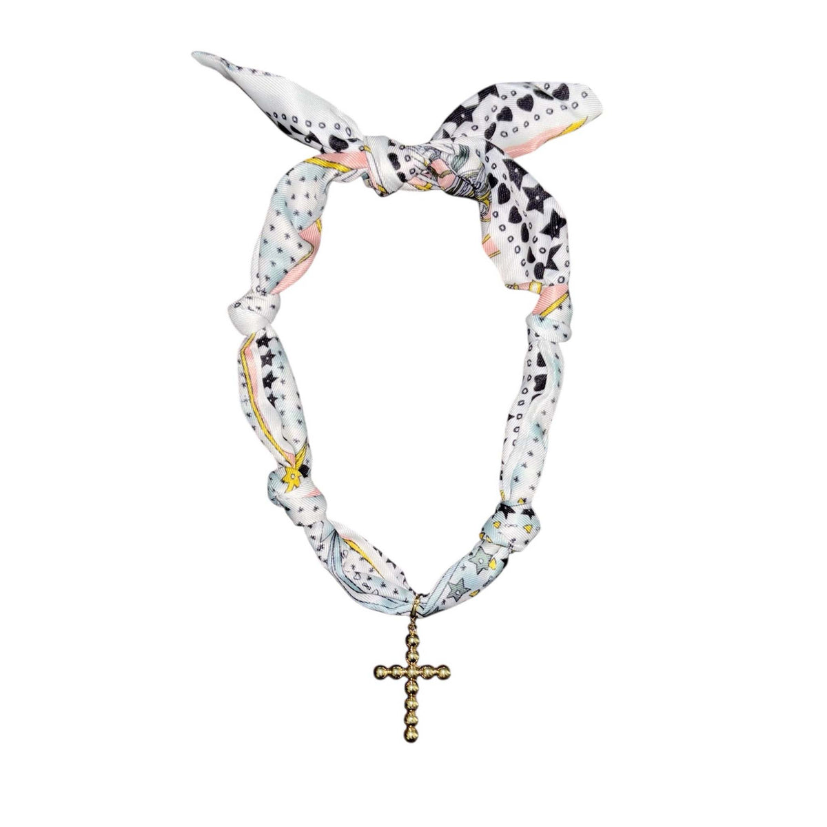 Knotted fabric necklace in white, blue, and pink pattern with gold-tone cross pendant hanging at the center.