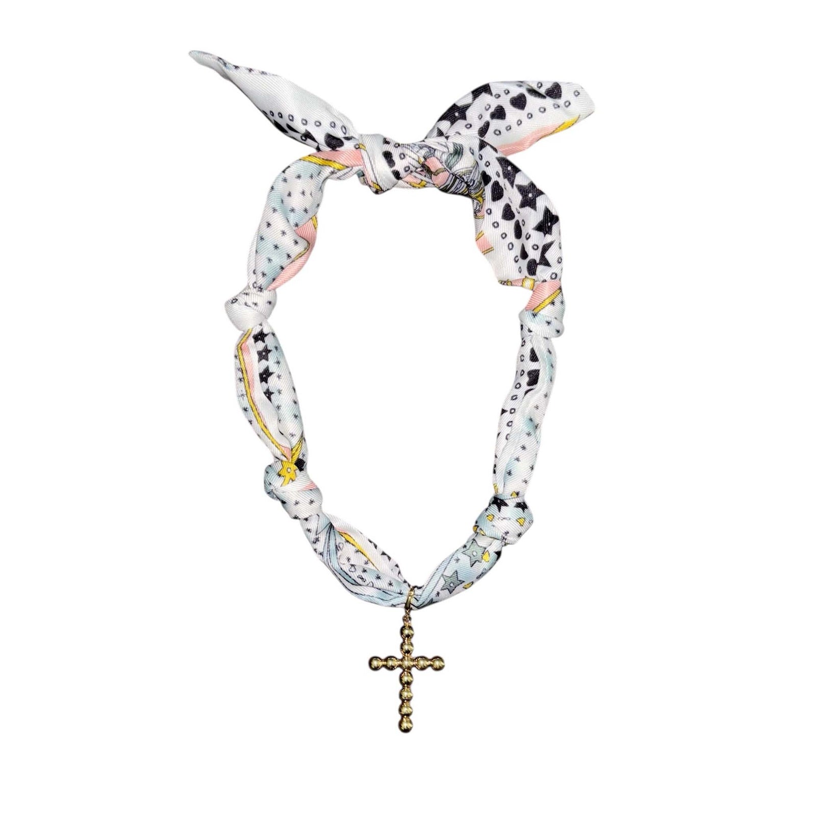 Knotted fabric necklace in white, blue, and pink pattern with gold-tone cross pendant hanging at the center.