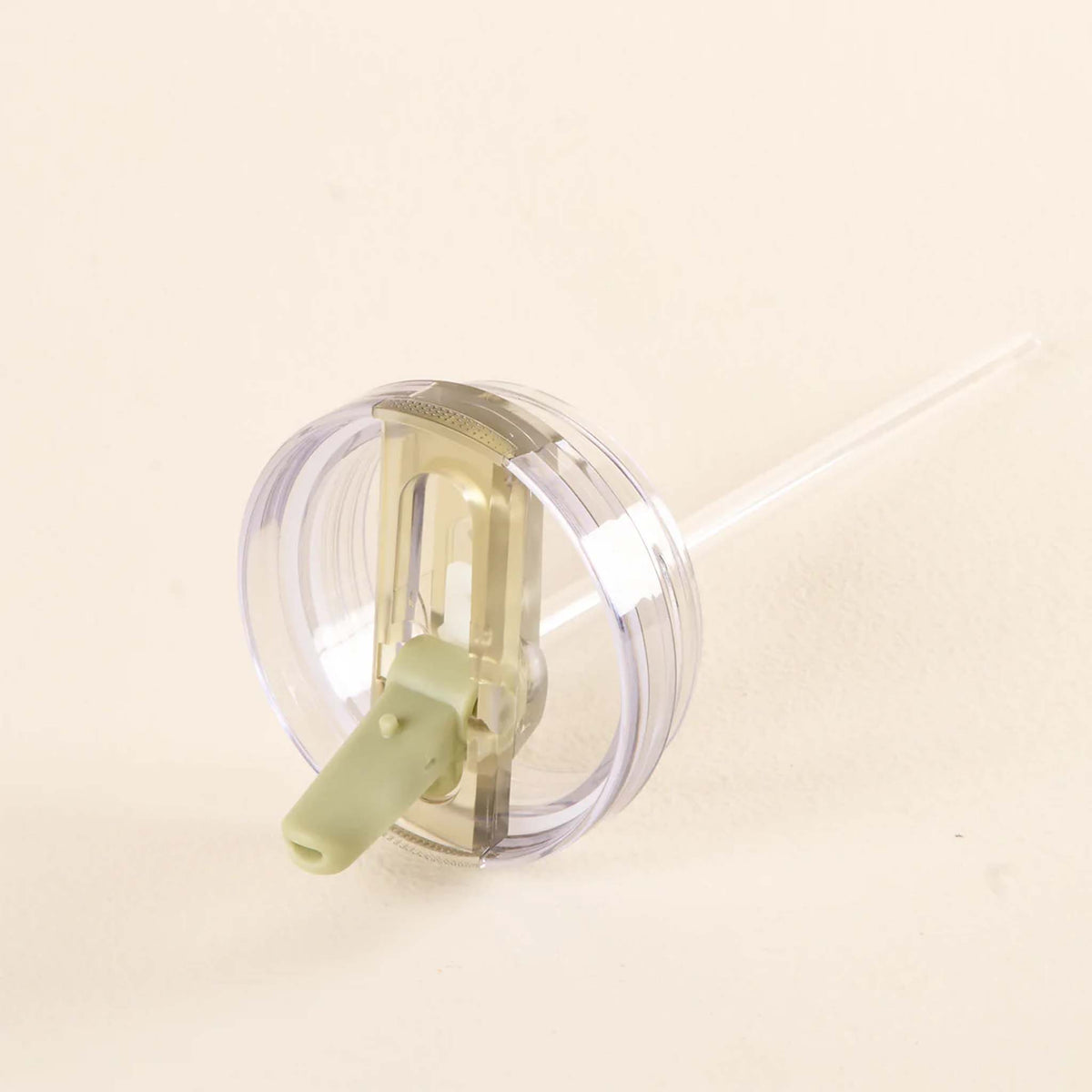Side view of the sage green flip straw lid with attached clear straw, shown on a neutral background.
