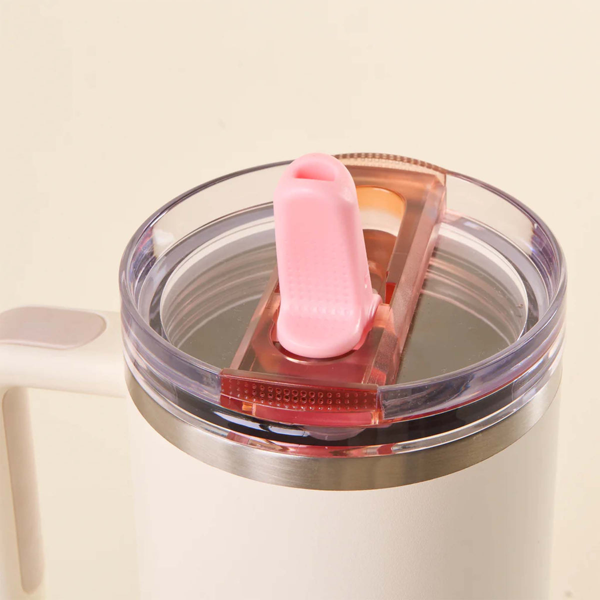 Close-up of pink flip straw lid on a white tumbler with the straw flipped open and ready for use.