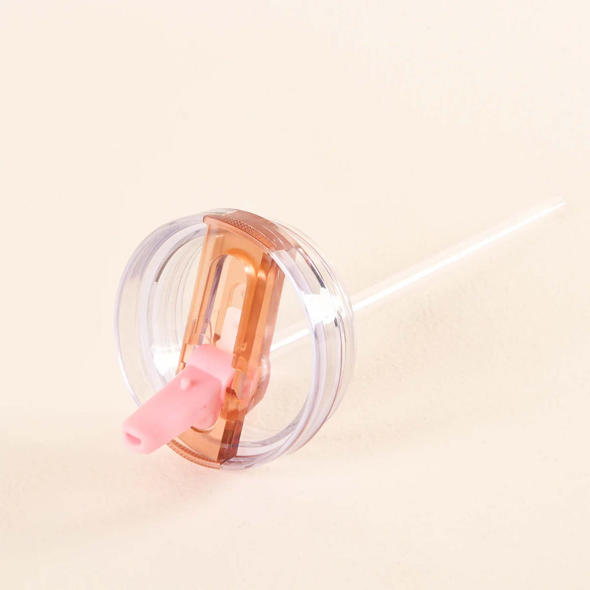 Side view of the pink flip straw lid attached to a clear straw, shown on a neutral background.
