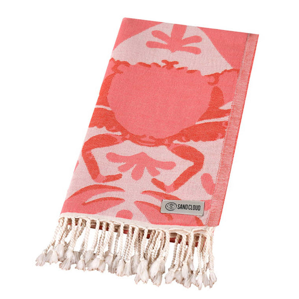 Sand Cloud Beach towel with peach crab pattern on a white background