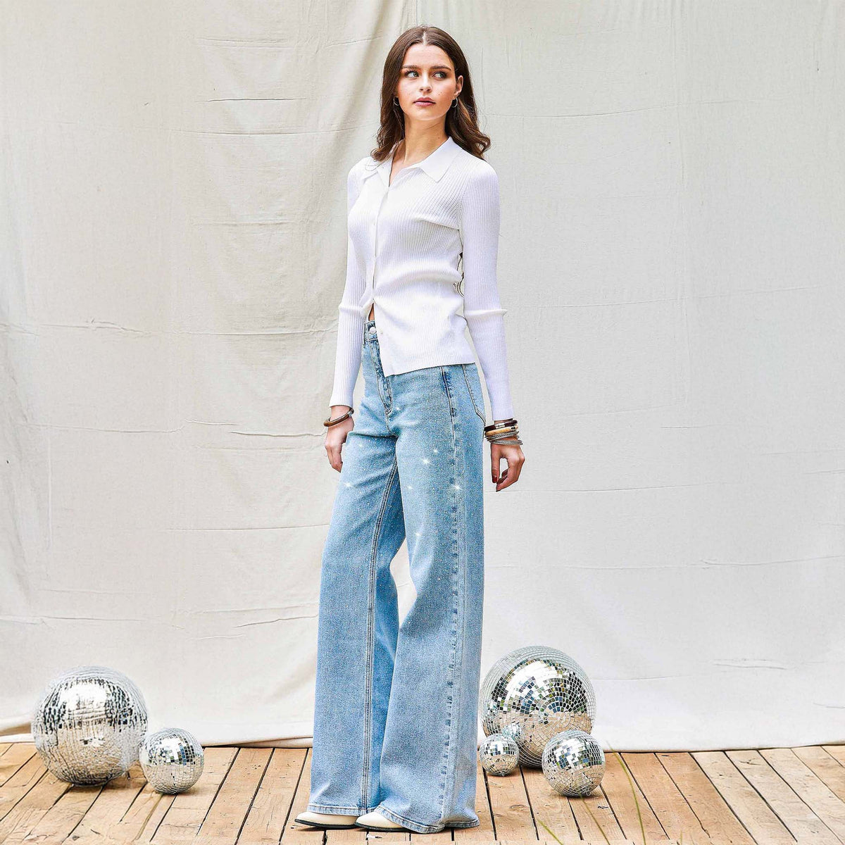 Woman wearing Vibrant Miu Rhinestone Straight Leg Light Wash Jeans