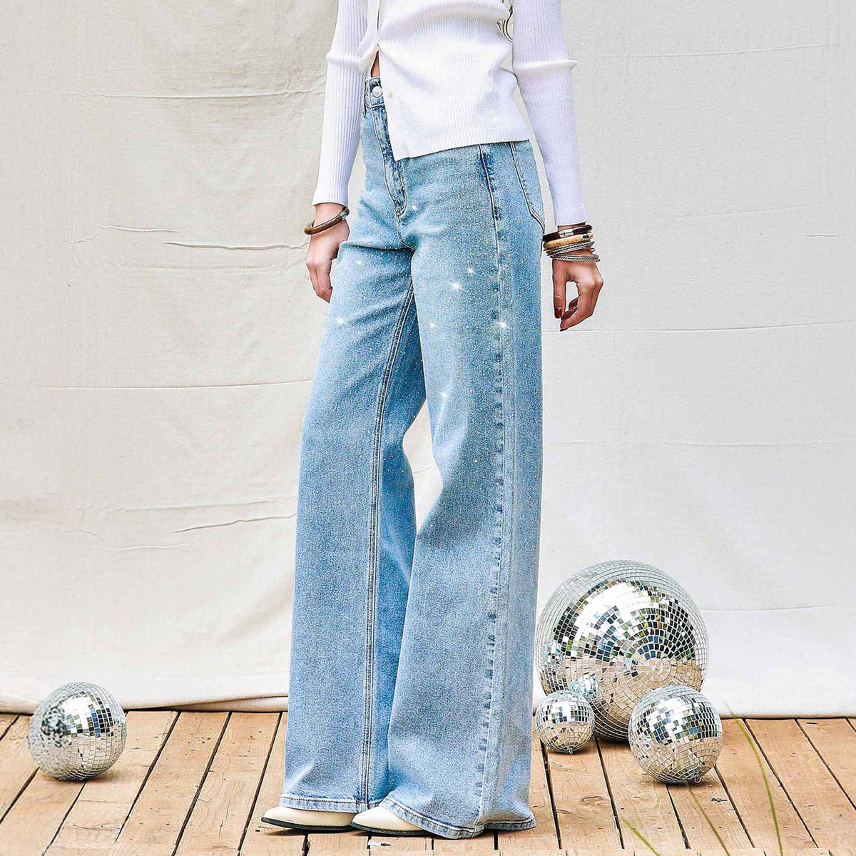 Woman wearing Vibrant Miu Rhinestone Straight Leg Light Wash Jeans