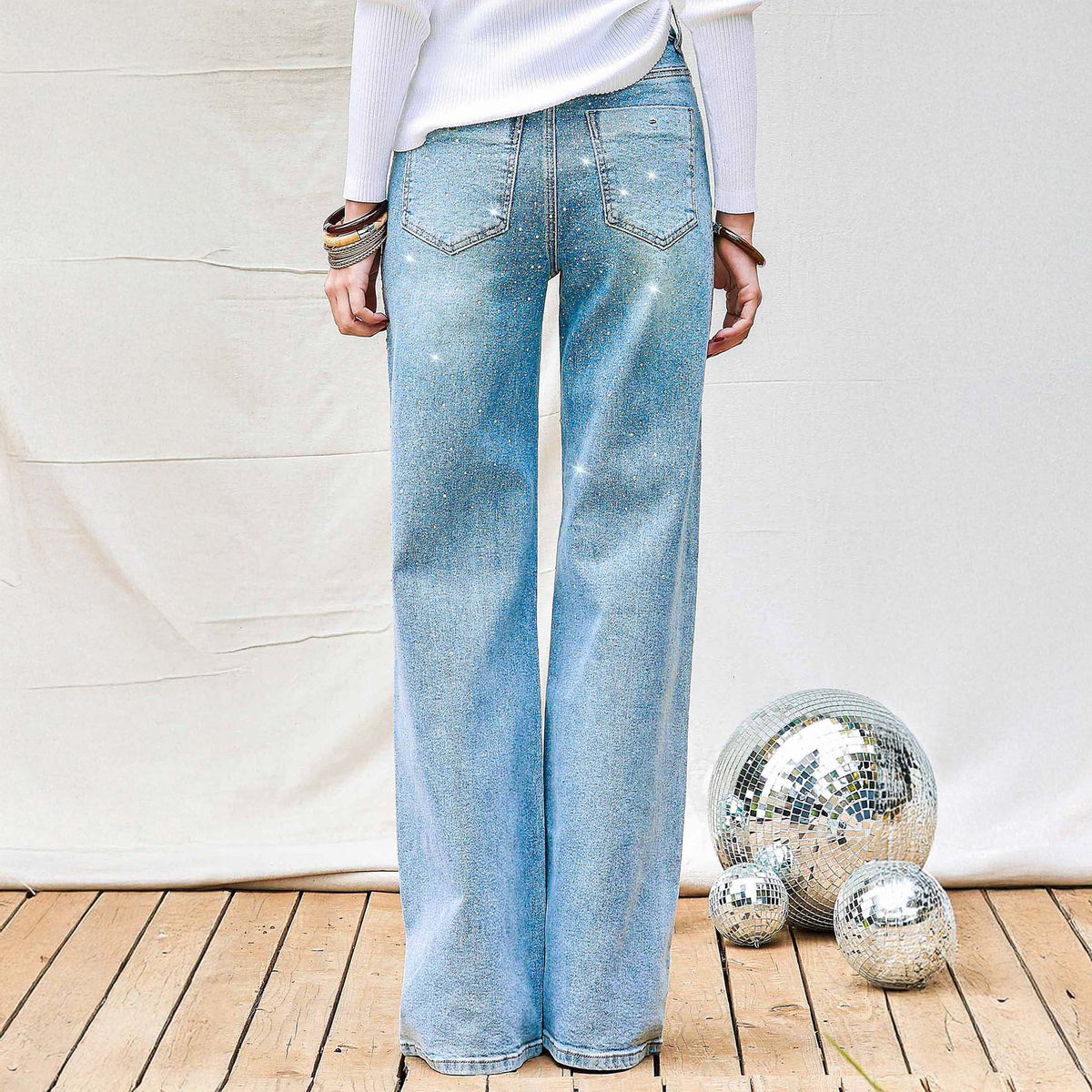 Woman wearing Vibrant Miu Rhinestone Straight Leg Light Wash Jeans