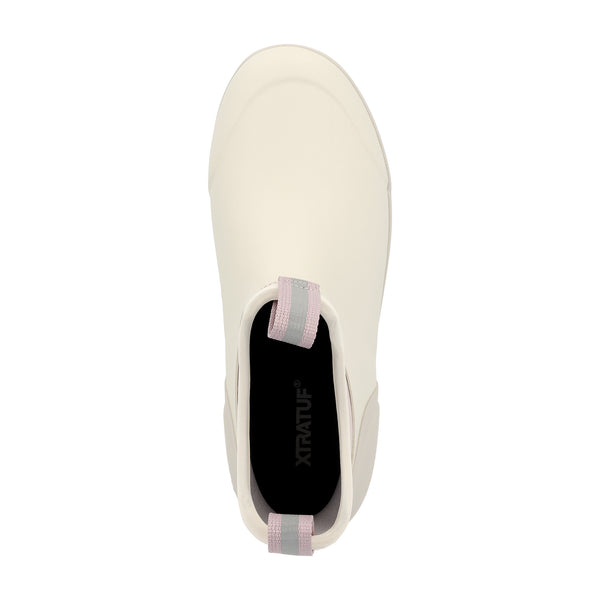Women’s 6-inch waterproof ankle deck boot in solid Ivory with a rounded toe, reinforced rubber upper, and slip-resistant outsole; features front and back pull-tabs for easy on and off, a cushioned insole for comfort, and a non-marking sole designed for wet surfaces.