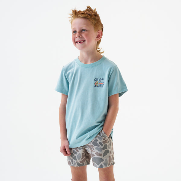 Child wearing Burlebo Youth Tackle Shop Short Sleeve T-Shirt in Sky Blue in front of a white backdrop.