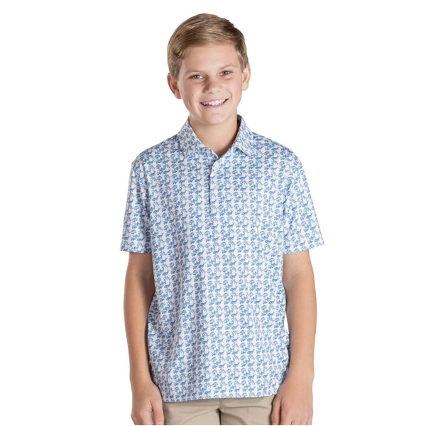 Young boy wearing a blue patterned polo on a white background