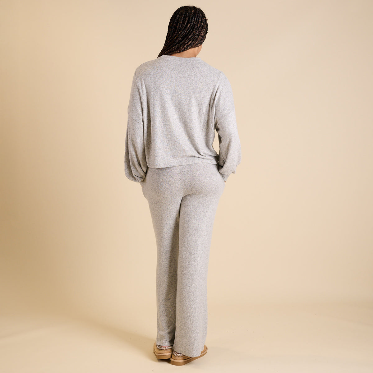 Woman wearing a grey lounge set.