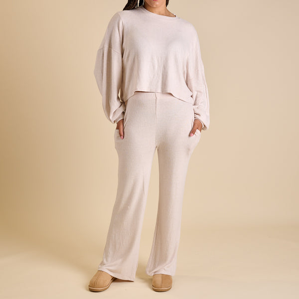 Woman wearing an oatmeal lounge set.