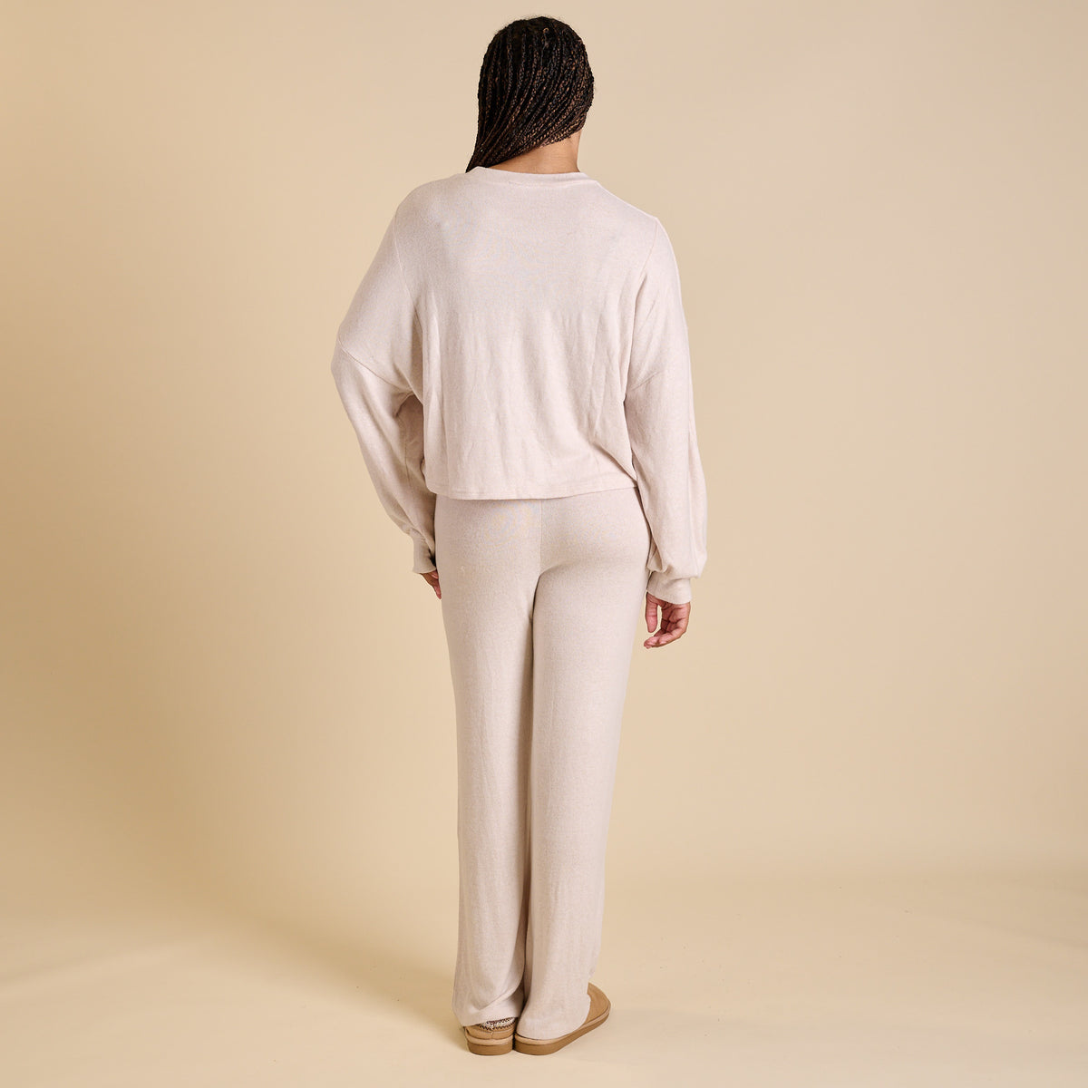 Woman wearing an oatmeal lounge set.