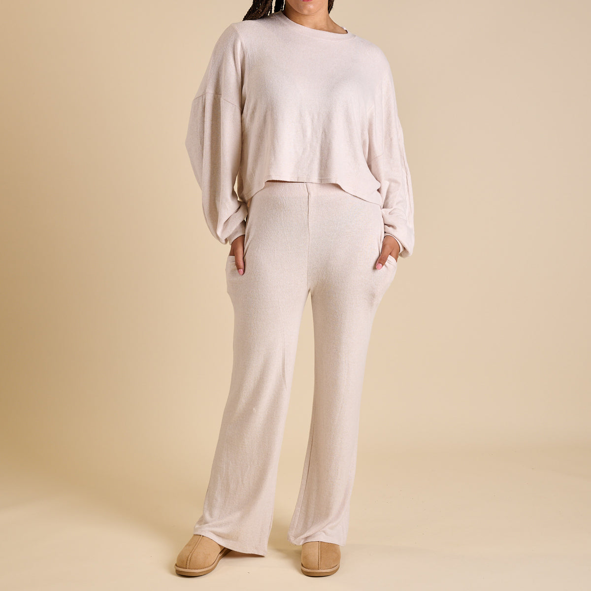 Woman wearing an oatmeal lounge set.