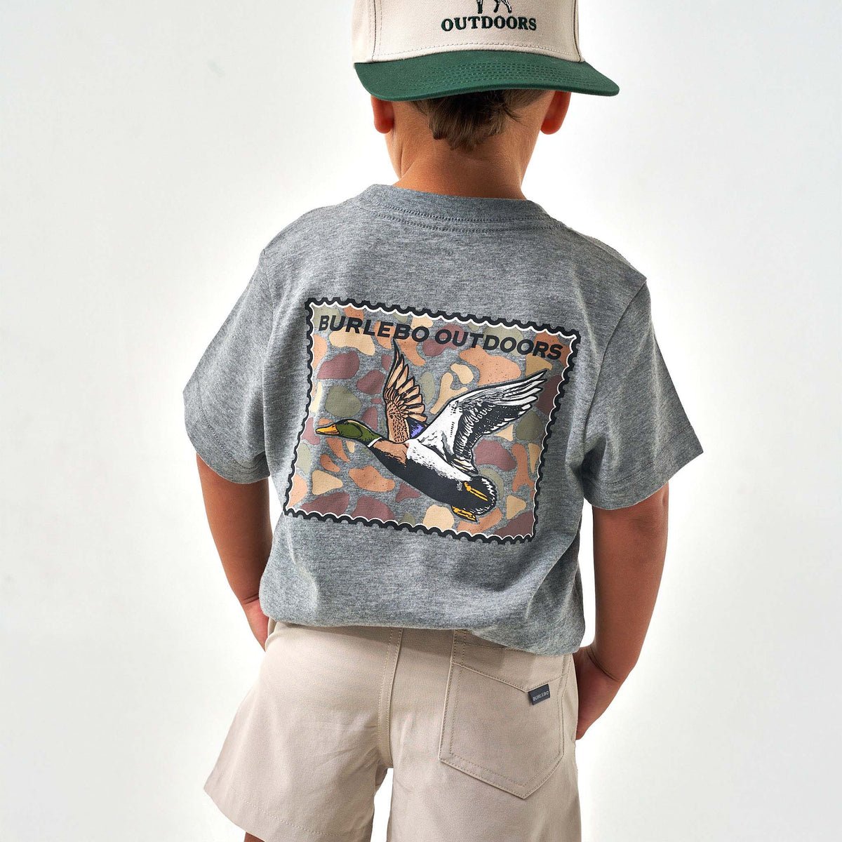 Person wearing a gray t-shirt with a duck design and 'Burlebo Outdoors' branding.