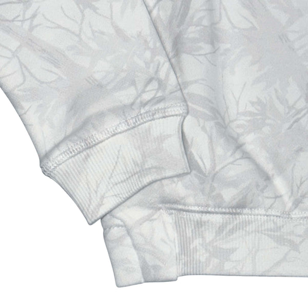 Close up of the sleeve cuff and hem of the Youth White woodland camo patterned mockneck sweatshirt on a white background
