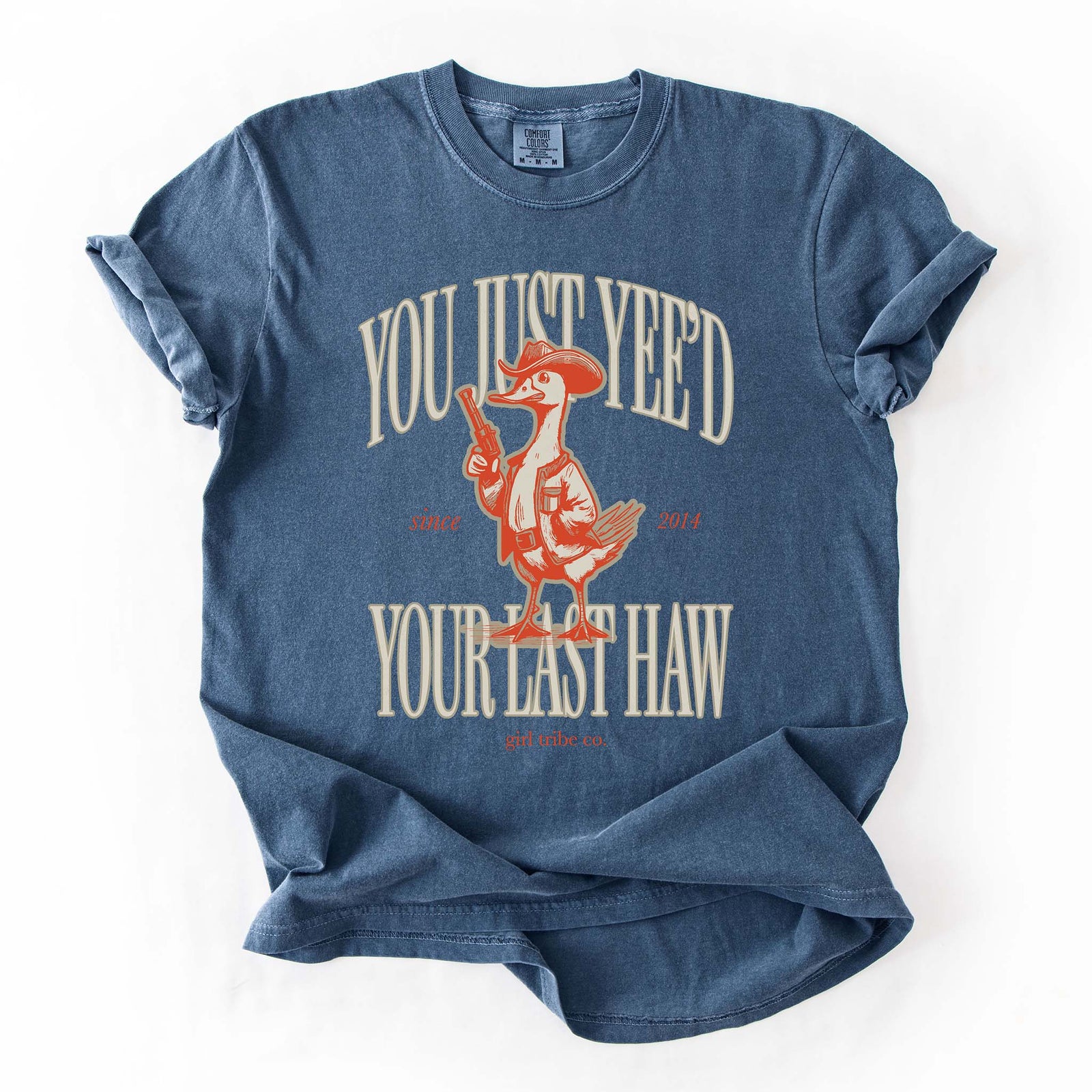 Blue t-shirt with a cartoon duck in a cowboy outfit holding a pistol. Text reads “You Just Yee’d Your Last Haw” with Girl Tribe Co. logo and "since 2014" in small print.