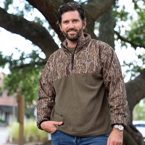 Man wearing a Drake camo pullover outside.