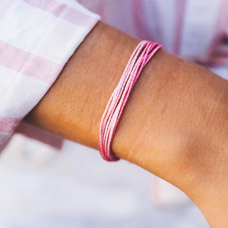 Pura Vida Pink and White Bracelet shown on a women&#39;s wrist